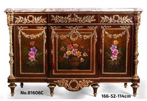 A French Louis XVI style ormolu-mounted veneer inlaid Sideboard, after the model by Martin Carlin, circa 1880 with eared breakfront moulded marble top above a frieze-drawer mounted with ribbon-tied ormolu laurel wreath, over three cupboard doors hung with floral garlands and decorated with paintings of flower and roses by our artists, all within Cyma Recta style ormolu borders, the fluted ormolu chinoises columnar angle supports over a shaped frieze, on six toupie feet